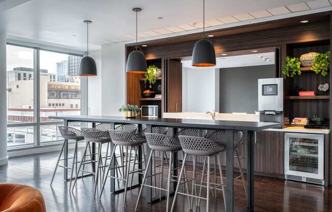 a kitchen with a large island with bar stools and chairs