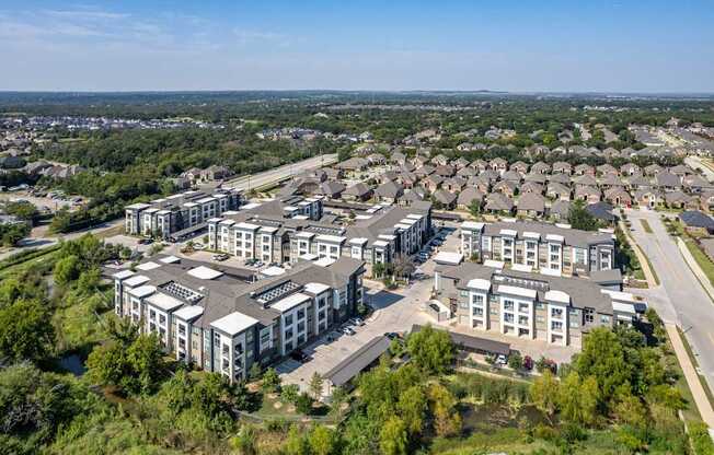 A bird's eye view of a residential area with multiple houses and buildings.