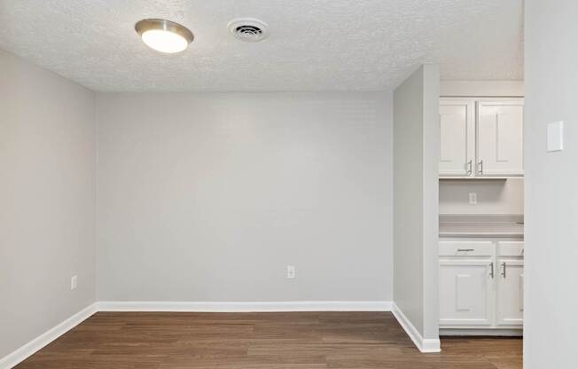 A room with a white ceiling and wooden floor.
