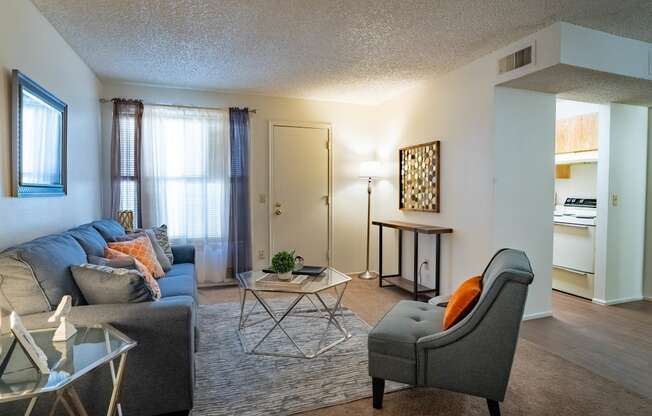 a living room with a couch and a chair and a table