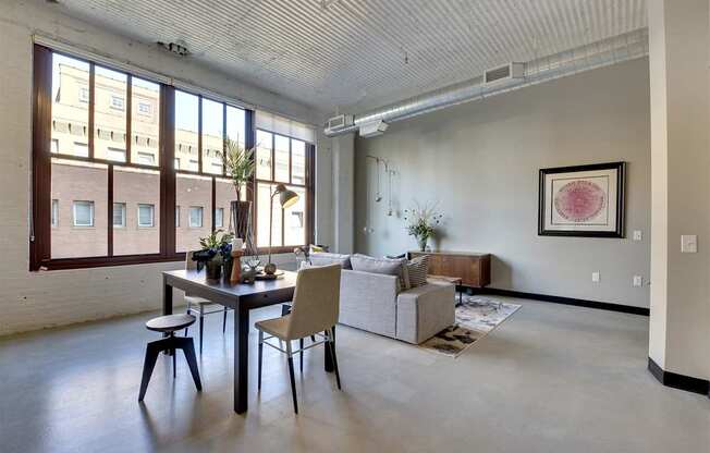 A dining room with a table and chairs.