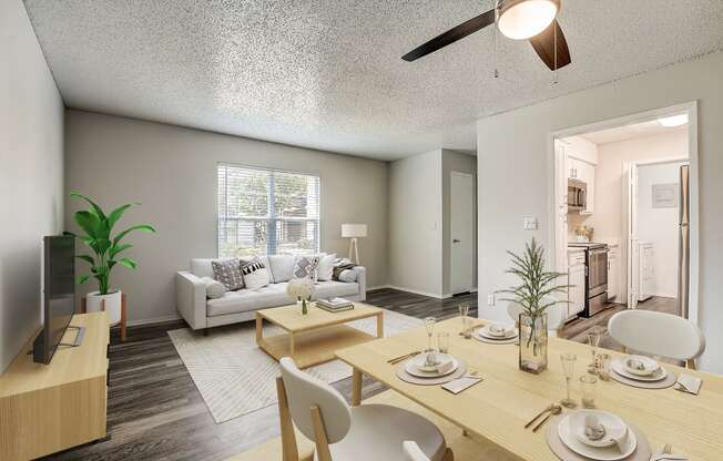 a living room and dining room with a ceiling fan