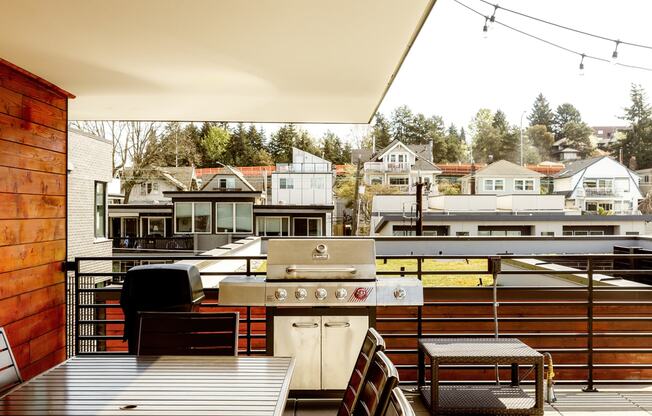 a kitchen with a grill and a table on a balcony