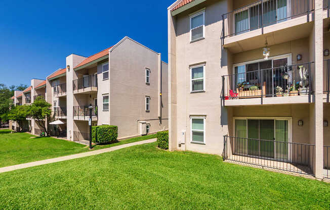 Apartment building with green space at Princeton Court Apartments in the Vickery Midtown neighborhood of Dallas, TX.