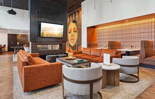 A living room with a fireplace and a painting of a woman on the wall.