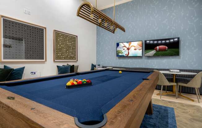 a game room with a pool table and a television