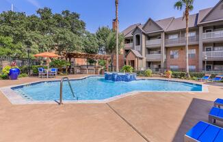 a house with a pool in front of a building