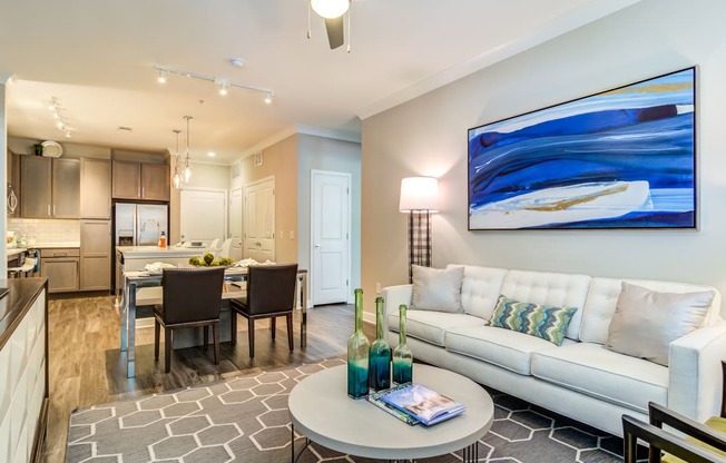 a living room and dining room area with a couch and a table