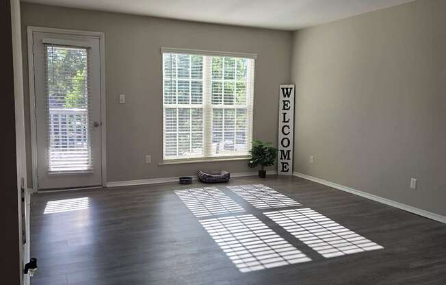 A room with a large window and a sign that says "Welcome".