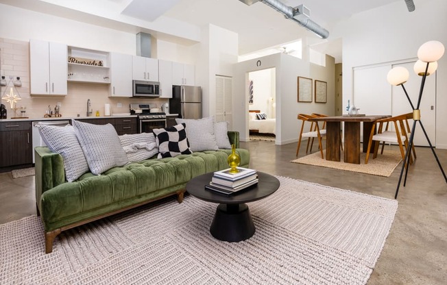 a living room with a green couch and a table