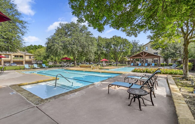 Pool With Lounge Chairs at The Canyons Apartments, Fort Worth, TX, 76116