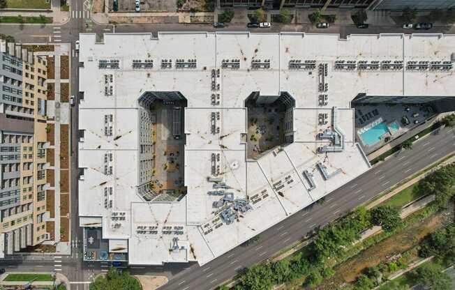 A large white building with a pool in the middle of it.
