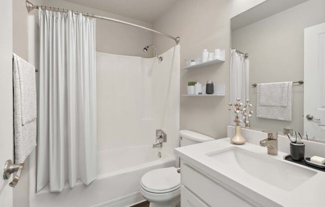 Model Bathroom with White Cabinets, Wood-Style Flooring and Shower/Tub at Walnut Creek Apartments located in Walnut Creek, CA.