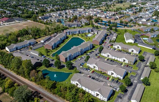 an aerial view of a city with houses and a pool