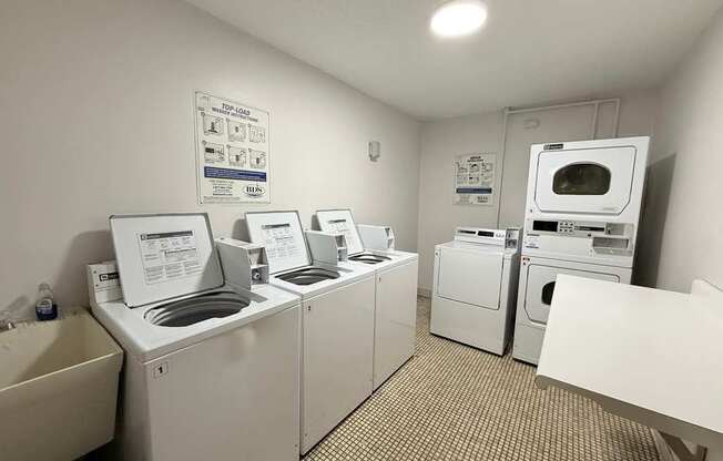 A laundry room with washers and dryers.