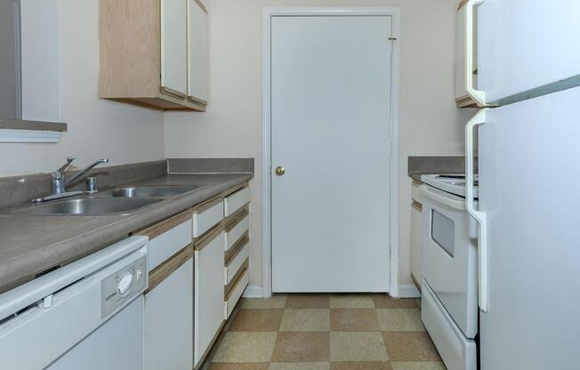 a white refrigerator freezer sitting inside of a kitchen