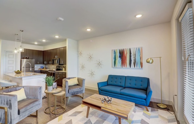 a living room with a blue couch and a coffee table