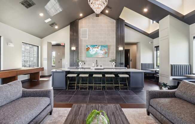 a clubhouse with a bar and a living room with couches at The Depot in The Depot Raymore, MO 64083