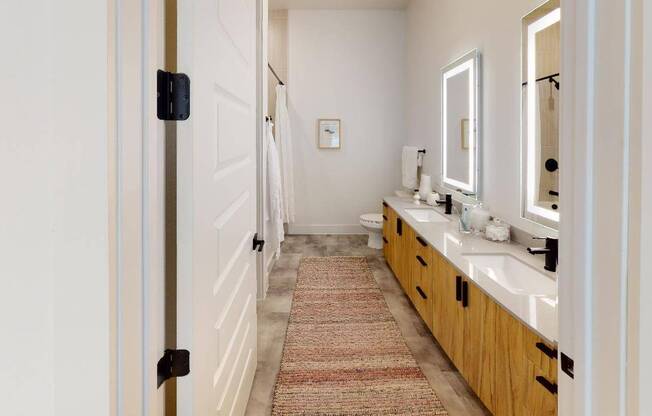 Enjoy luxe bathrooms with backlit bathroom mirrors, upgraded fixtures, and quartz countertops
