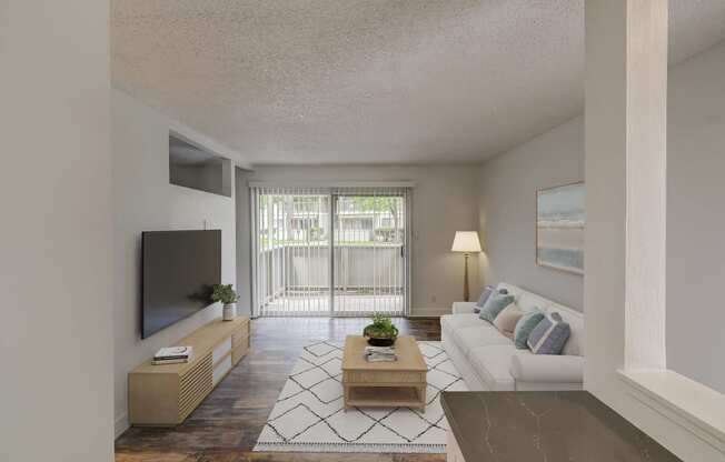 a living room with a white couch and a television