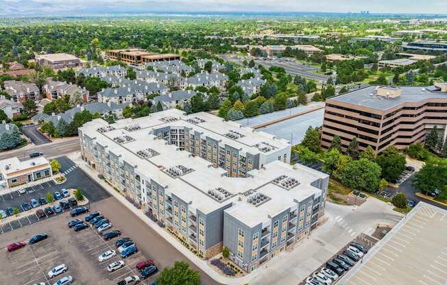 a large white building with a parking lot in front of it