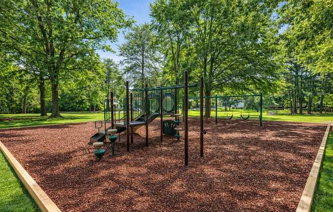 A playground with a swing set and a slide.