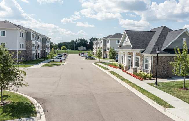 Photo of drivway to apartment homes in the community, clubhouse to thr right, apartment homes to the left.