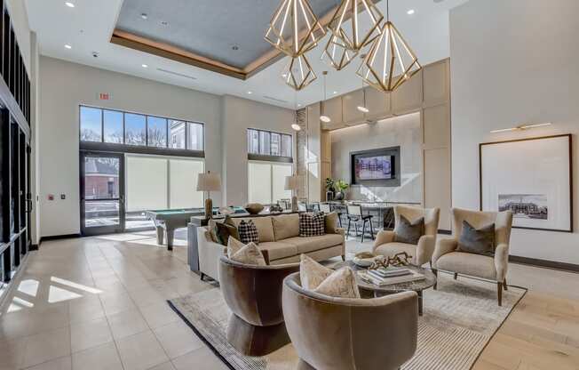 a living room with couches and chairs and a table and a pool