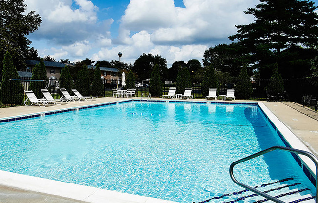Swimming Pool with outdoor seating around the pool at Briarwood Apartments in Columbus, IN