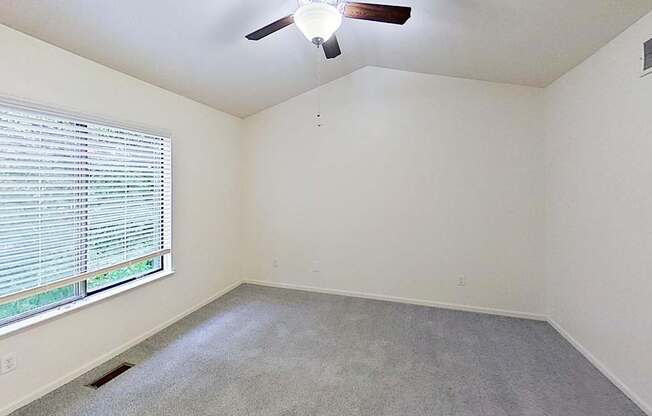 Master bedroom with a cathedral ceiling and ceiling Fan at Foxwood and The Hermitage, Portage, MI