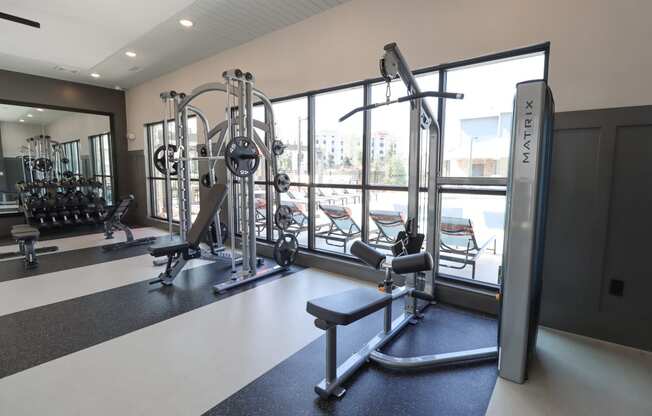 a gym with exercise equipment and windows in a building at The Crest at Acworth, Acworth, 30102