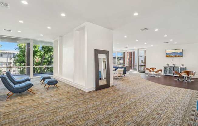 A spacious waiting room with a view of the outdoors through large windows.