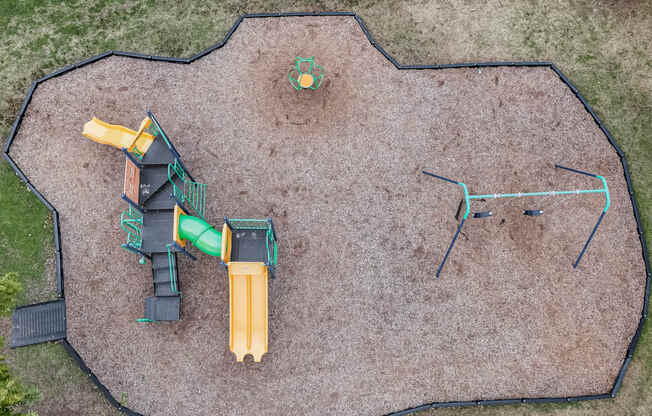 an aerial view of a playground with a yellow  green  and
