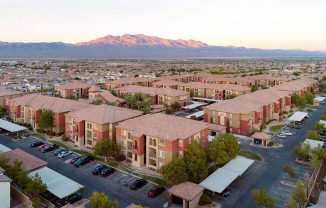 an aerial view of a city with mountains in the background