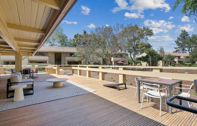 a patio with tables and chairs on a balcony at Summerwood Apartments, Santa Clara, CA 95050