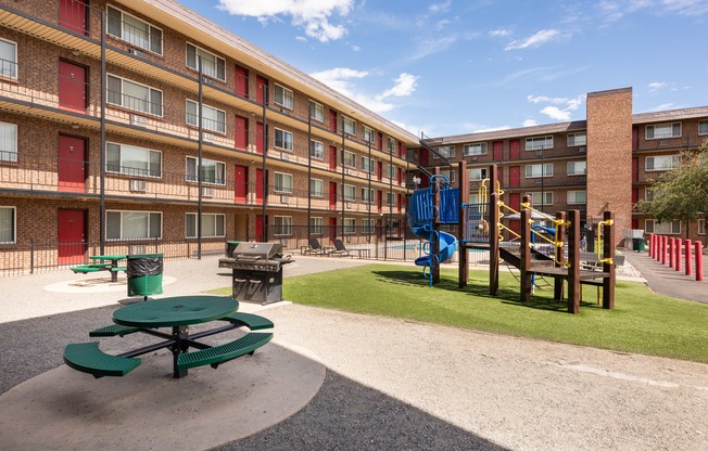 a playground in the courtyard of an apartment building