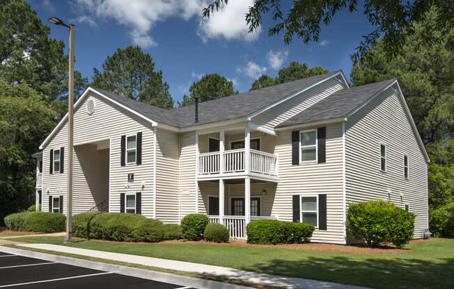 a white house with a porch and a balcony