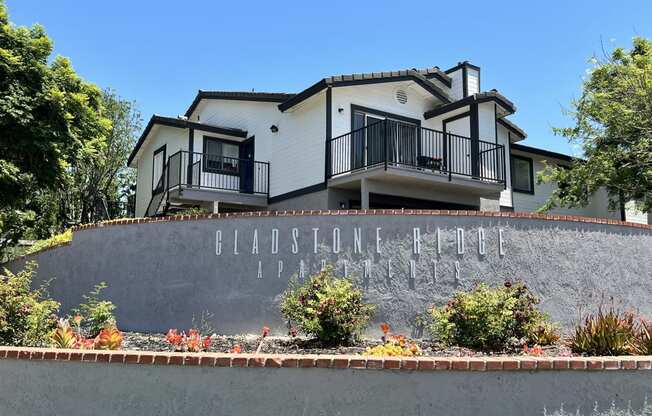 a retaining wall with a house behind it