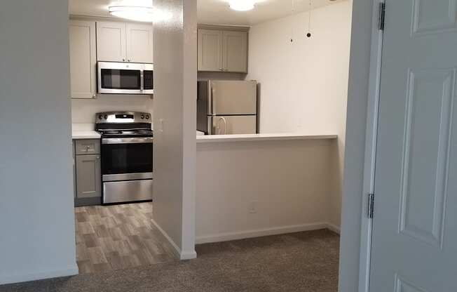 2x1 kitchen with a fan and stainless steel appliances