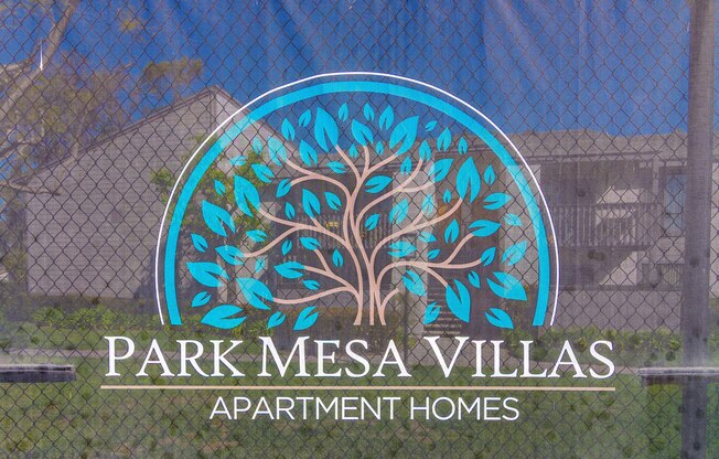 A sign for Park Mesa Villas Apartment Homes with a tree logo.
