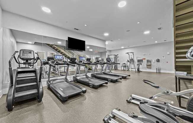 a gym with cardio equipment and treadmills