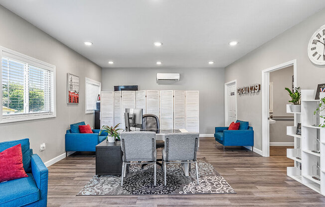 a living room and dining room with a table and chairs