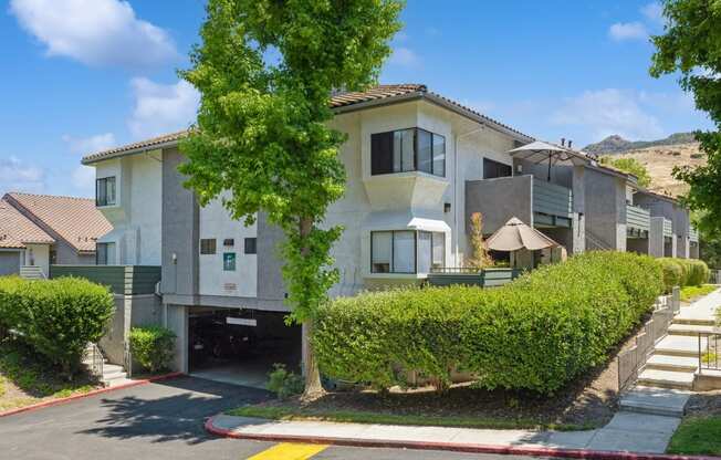 the view of an apartment building from the street