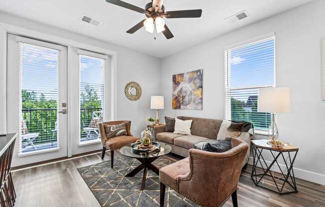 A living room with a brown chair and a brown couch.