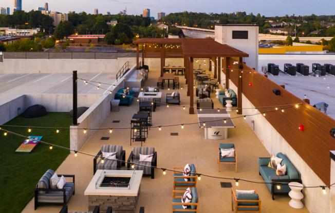 Outdoor lounge at our apartments in Atlanta, GA, featuring outdoor cushioned chairs and a shade structure.