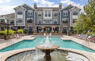 building exterior with water fountain and swimming pool