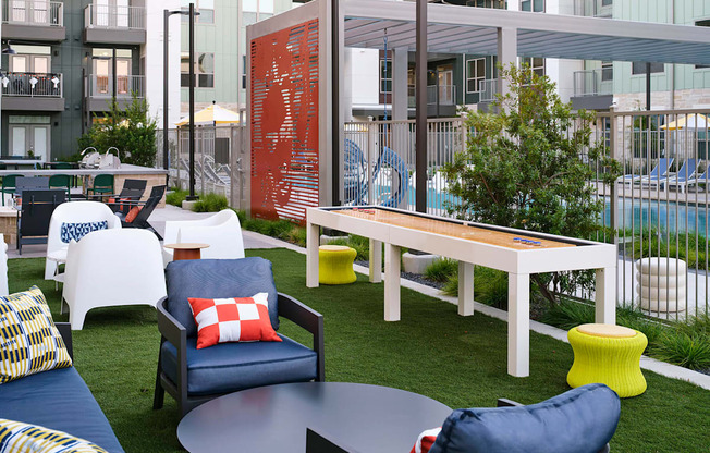 a communal area with chairs and tables and a pool