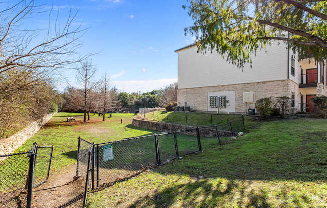 A white building with a green lawn in front of it.