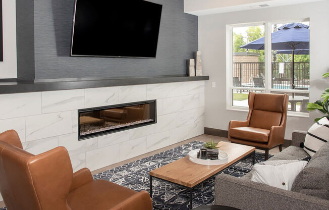 Community room lounge with fire place and tv at Urban Park I and II Apartments, Minnesota, 55426