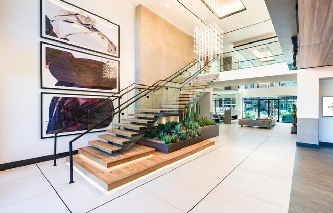 A sculptural staircase, statement lighting, and soaring ceilings create a striking entry that sets the tone from the moment you arrive.